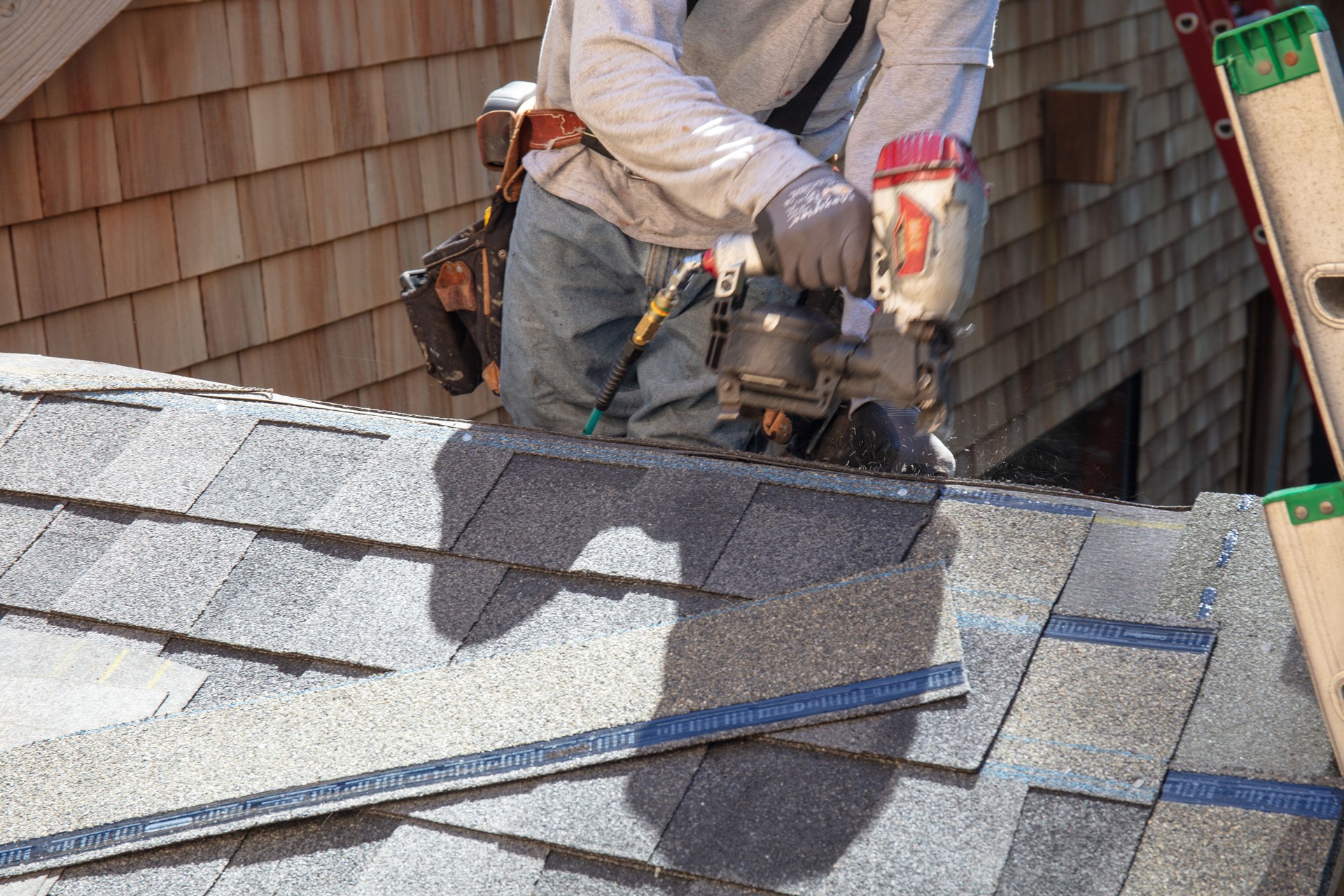 Man installing asphalt roof