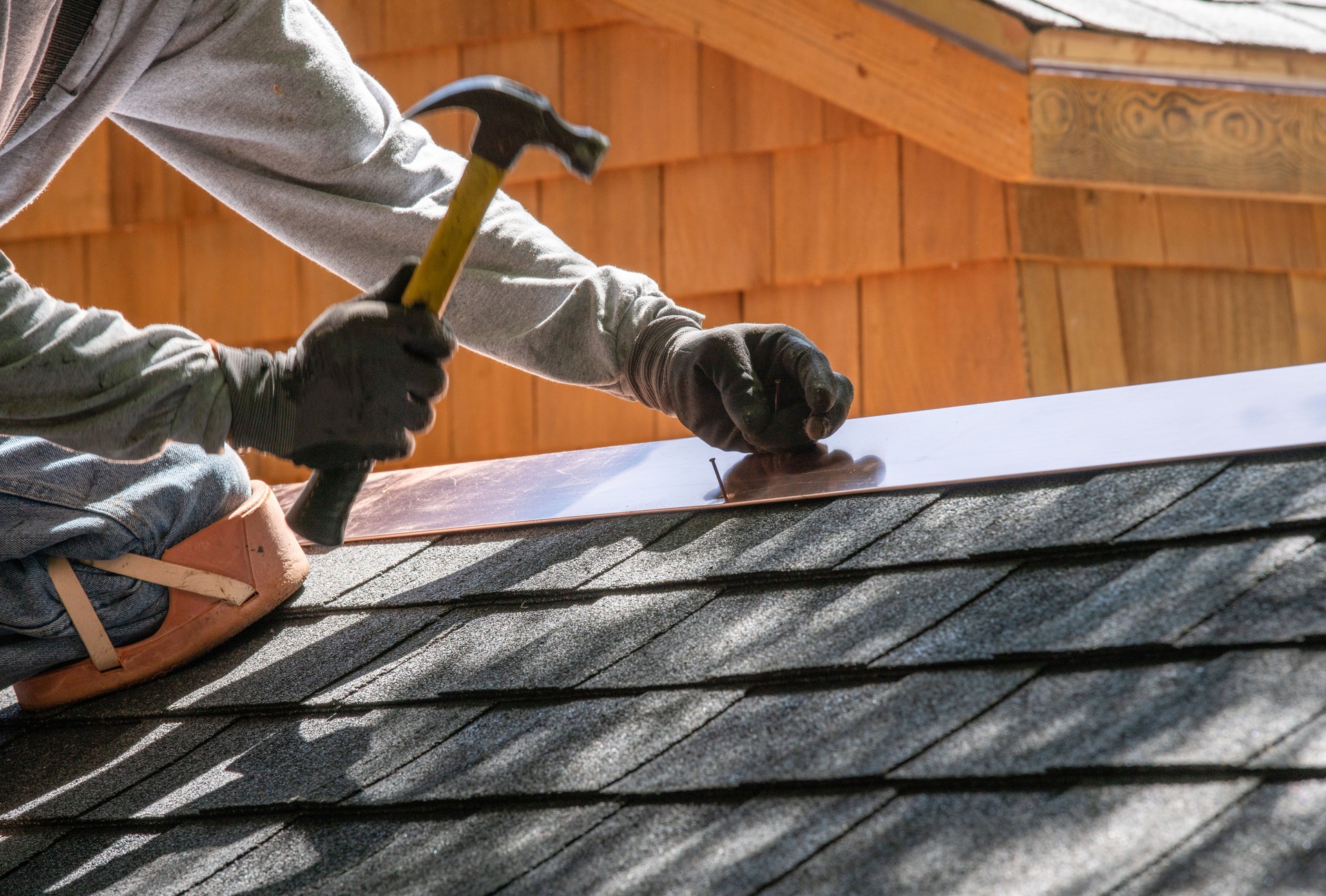 Installing new roof with hammer